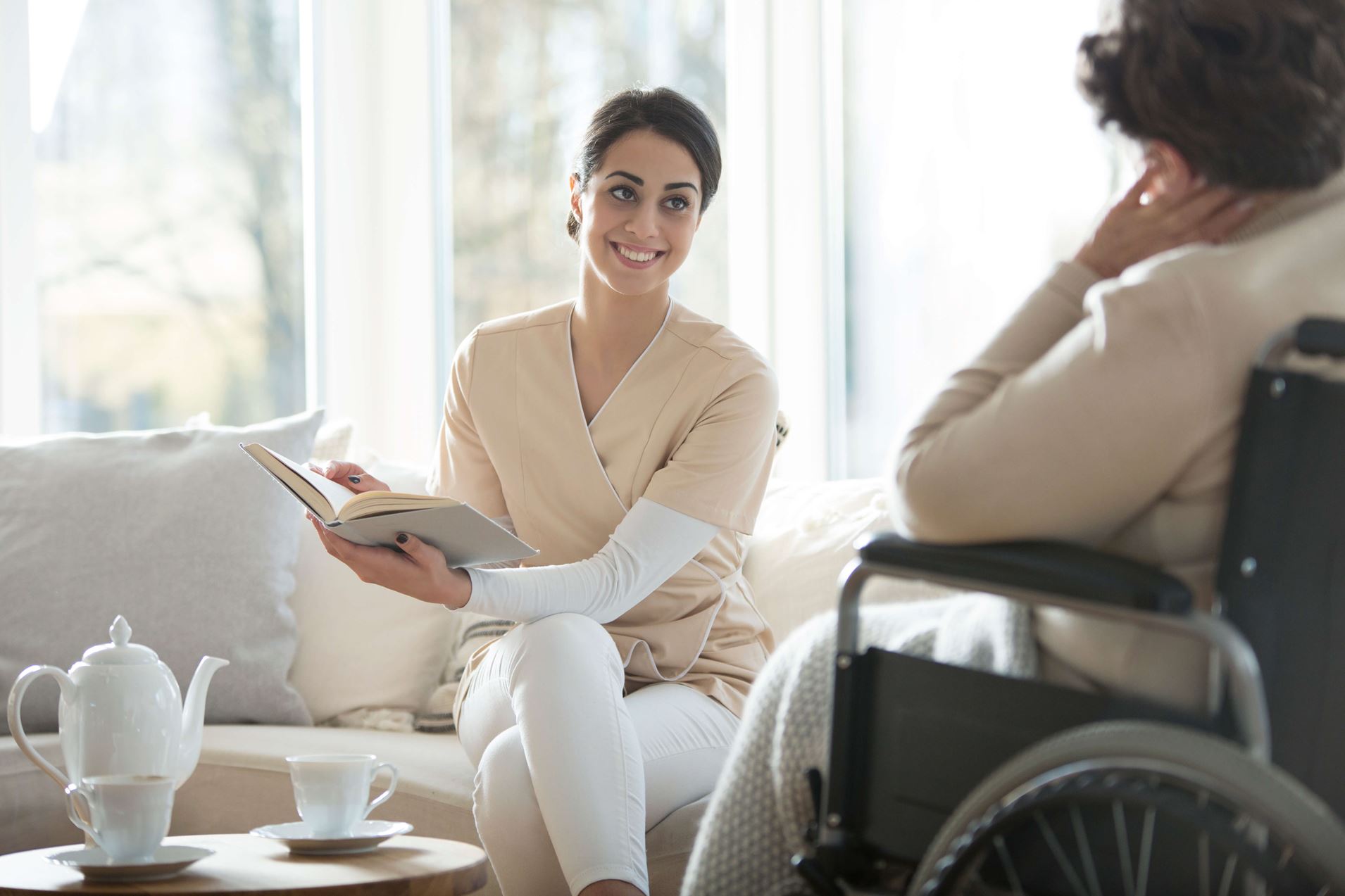 Caregiver reading to woman